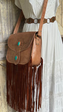 Load image into Gallery viewer, Wild Sierra handcrafted tan leather fringe shoulder bag styled with a white bohemian dress, featuring turquoise stones and flowing double suede fringe.