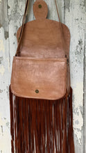 Load image into Gallery viewer, Wild Sierra handcrafted tan leather fringe crossbody bag with front flap open, showing the spacious compartment, magnetic snap closure and long double suede fringe.