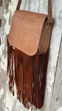 Load image into Gallery viewer, Rear view of Wild Sierra handcrafted tan leather crossbody bag showing smooth leather back, adjustable hand-tooled strap and long double-layered suede fringe.