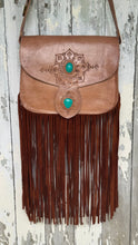 Load image into Gallery viewer, Wild Sierra handcrafted tan leather crossbody bag featuring two turquoise stones, intricate hand-tooled detailing and long double suede fringe.