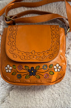 Load image into Gallery viewer, Wildflower Bloom hand painted and hand tooled genuine leather crossbody bag in tan with colourful floral artwork and adjustable strap.