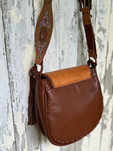 Load image into Gallery viewer, Rear view of Wildflower Dreamer hand tooled leather boho crossbody bag with tassel detail and smooth genuine leather back