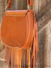 Load image into Gallery viewer, Back view of genuine tan leather boho fringe bag with long leather fringe and adjustable crossbody strap